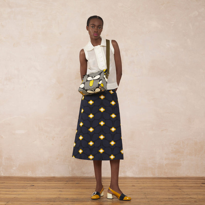 Model wearing the Fielder Crossbody in Giant Striped Tulip Noir pattern by Orla Kiely