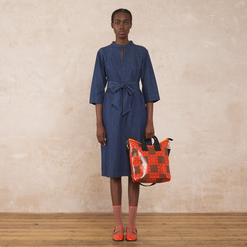 Model wearing Carry Grab Bucket Bag in Lattice Flower Tile Conker pattern by Orla Kiely