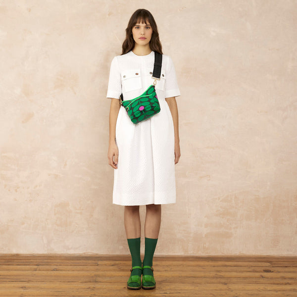 Model wearing the Carrymin Crossbody in Sixties Stem Emerald pattern by Orla Kiely