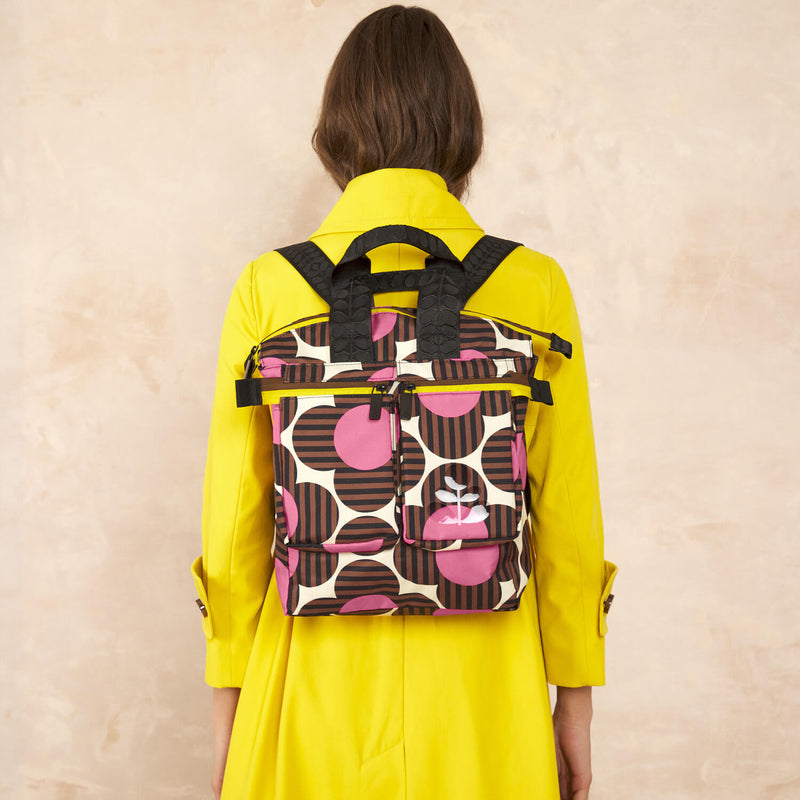 Model wearing the Axis Medium Backpack in Striped Flower Azalea pattern by Orla Kiely