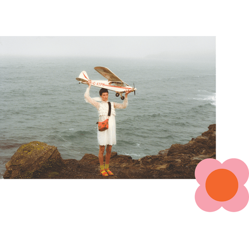 Model wearing Cross Carry Crossbody in Lattice Flower Tile Conker pattern